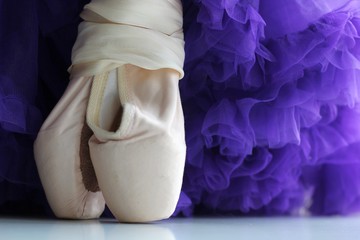 Ballet dance shoes and purple lace skirt with rhyches. Pink satin ribbons. Children's dream