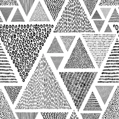 Wall murals Triangle Hand-drawn triangles in doodle style seamless pattern. Black and white print for textiles. Ethnic and tribal motifs.