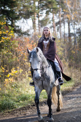 Obraz premium Young woman with a horse
