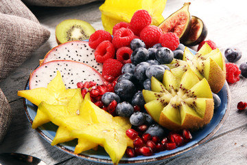 fruit bowl. Bowl of healthy fresh fruit salad on rustic background