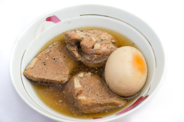 This dish is called Pork and Egg Stew or Caramelized Pork and Eggs (Thit Kho Trung). It is usually served with steamed rice and cooked vegetable or pickled vegetable. It is made of fresh coconut water
