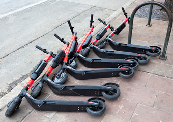 Electric scooters left on sidewalk.