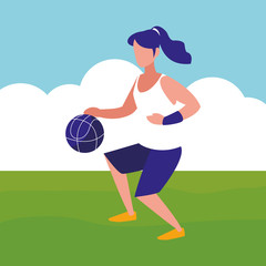 young woman playing basketball