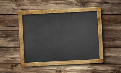 blank slate blackboard and wooden background
