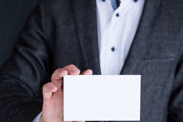 blank white paper in man hands. business card concept. empty space for text.
