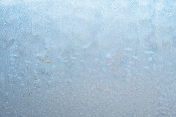 Winter background, frozen glass from strong frost, ice texture on the window