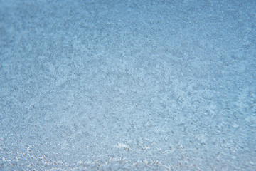 Winter background, frozen glass from strong frost, ice texture on the window