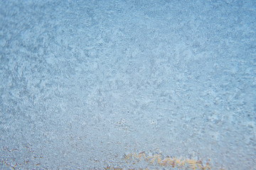 Winter background, frozen glass from strong frost, ice texture on the window