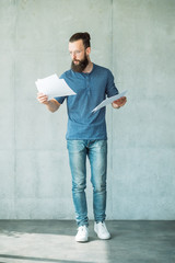 man reading script on papers. focused consumed screen writer