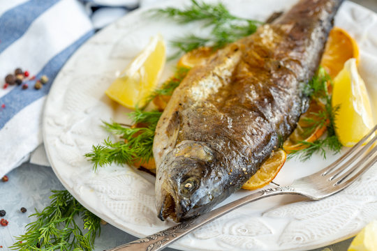 Baked lake trout with lemon and dill.