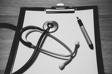 Stethoscope, pen and paper tablet