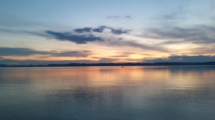 Fototapeta na wymiar Breathtaking sunset at lake Balaton with a small boat afar