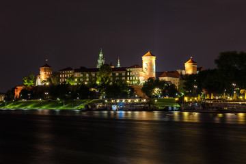 Fototapeta na wymiar Wawel Castle in the evening in Krakow with reflection in the river, Poland. Long time exposure