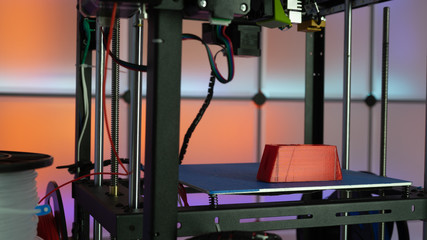 3d printer and plastic filament on color background