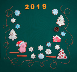 New year background with festive biscuits, decor and a symbol of 2019 - pig (greeting card, greetings - concept)