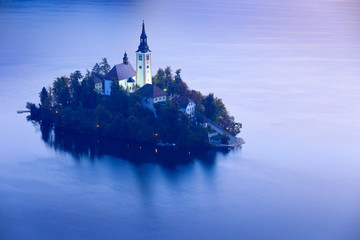 Twilight evening light in, Bled, Slovenia.  lake island, St Martin Catholic church and Castle with...