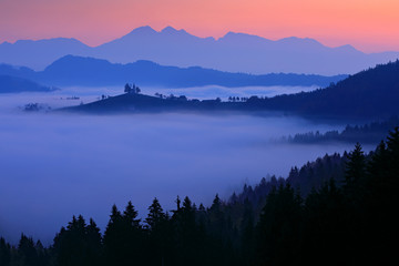 Landscape in Slovenia, nature in Europe.  Foggy Triglav Alps with forest, travel in Slovenia. Saint...