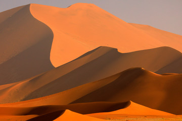 Big orange dune with blue sky and clouds, Sossusvlei, Namib desert, Namibia, Southern Africa. Red...