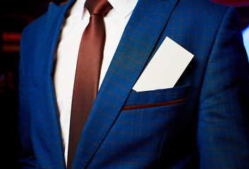 White business card in a jacket pocket