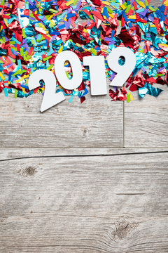 NYE2019: Wooden 2019 Year Number On Confetti Background