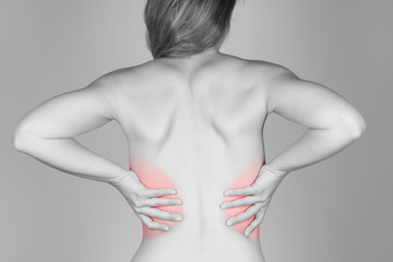 Woman holding her lower back in pain