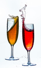 Colorful splash in champagne glass isolated on white background