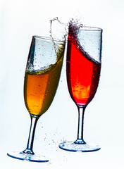 Colorful splash in champagne glass isolated on white background