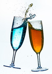 Colorful splash in champagne glass isolated on white background