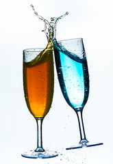 Colorful splash in champagne glass isolated on white background
