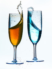 Colorful splash in champagne glass isolated on white background