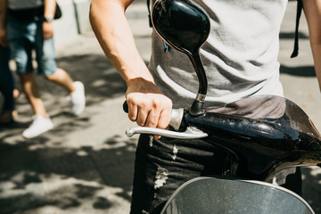 The tourist is going to use an electric scooter. Popular vehicle in Berlin in Germany.