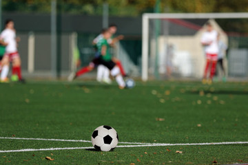 Young boys playing a football match and empty space for text