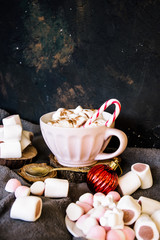 Good New Year spirit. Coffee with marshmallows and cinnamon. Candy canes. Pink mug. Cooking yourself. Home comfort. New Year. Christmas time. Winter mood.