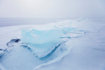 Turquoise ice floe. Winter landscape of Baikal lake