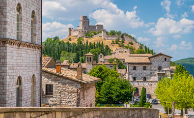 Scenic view in Assisi with the Rocca Maggiore and olive trees. Umbria, Italy. - obrazy, fototapety, plakaty