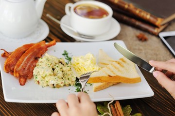 tea with lemon on the background of breakfast, burlap, old books, mobile phone and wooden table