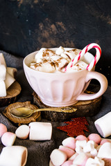 Good New Year spirit. Coffee with marshmallows and cinnamon. Candy canes. Pink mug. Cooking yourself. Home comfort. New Year. Christmas time. Winter mood.