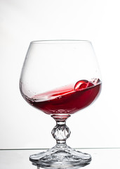 A glass of white wine on white background close up still life image