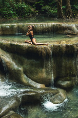 Fototapeta na wymiar Sexy woman in the jungle with beautiful waterfall