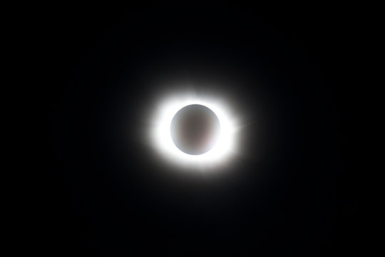 total solar eclipse with corona and solar eruptions