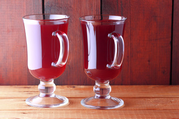 Mulled wine on wooden boards. Christmas mulled wine in glass cups. Alcoholic drink of wine and...