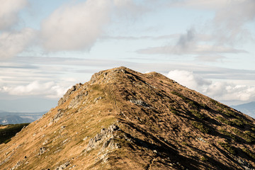 hills covered by mountain meadows and smaller rocks during nice autumn day © honza28683