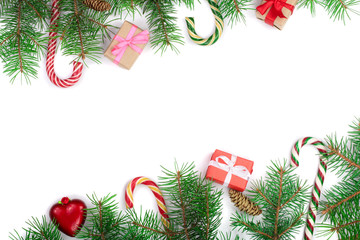Christmas Frame of Fir tree branch with candy canes and boxes isolated on white background with copy space for your text