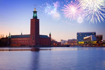 Foto op Canvas waterfornt of Stockholm with city hall at night with fiewworks, Sweden © neirfy