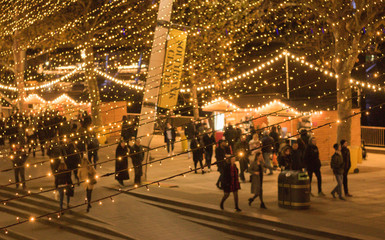 Blurred background of bright festive lights on a busy evening street. Image text `Southbank...