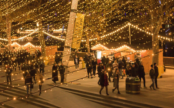 Blurred background of bright festive lights on a busy evening street. Image text `Southbank Centre`. Concept: beautiful Christmas atmosphere of city.