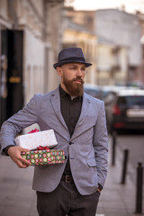 stylish man goes to a meeting with gifts