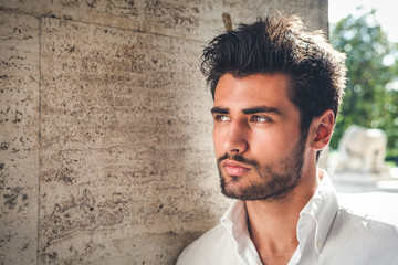 Handsome young man portrait. Intense look and eye-catching beauty. Fashionable hair and beard. The...