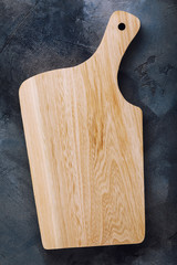 Clean chopping board on a table, top view. Food background