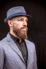 Fototapeta na wymiar fashion man with a beard in a hat